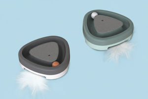 Close-up of automatic electric cat toy with smooth triangular design