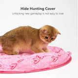 Cat playing under the hunting cover with rolling toy ball
