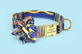 Assorted colorful floral dog collars with bows and personalized tags