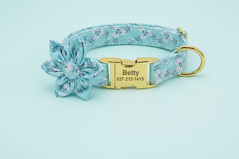 Teal floral printed dog collar with engraved name plate and flower accent